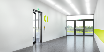 Moderner Gebäudekorridor mit Notausgangstüren und heller Beleuchtung